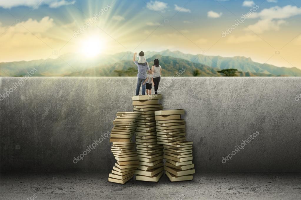 depositphotos_76601325-stock-photo-family-using-books-to-look